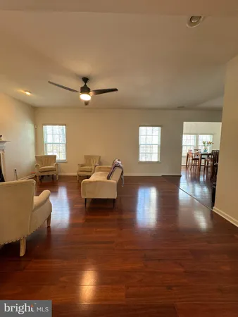 a living room with furniture and a view of kitchen
