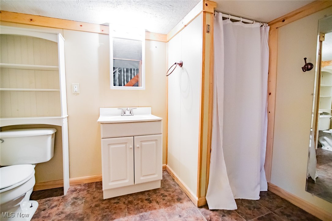 91 Mike Street Washington, WV 26181 - Photo 28 of 42 Bathroom with a shower with shower curtain, vanity, and a textured ceiling