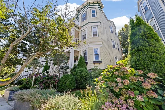 an aerial view of a residential apartment building with a yard