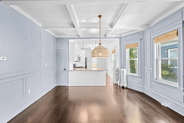 a view of a big room with wooden floor windows and chandelier