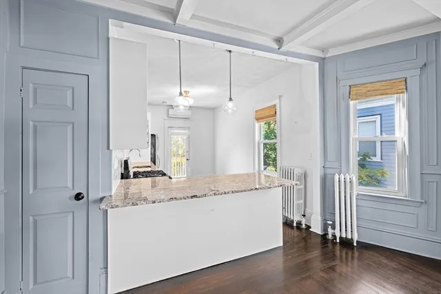a bathroom with a granite countertop sink a mirror and a shower