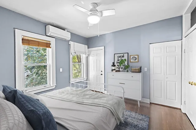 a bedroom with a bed and a window