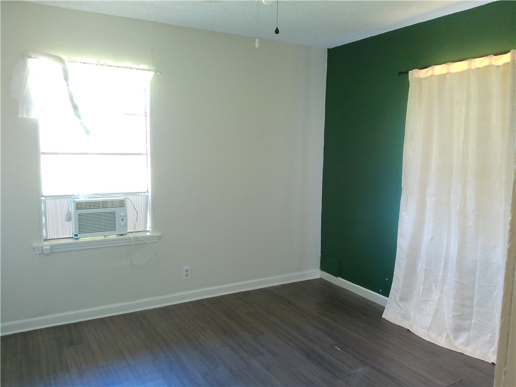 4006 McArdle Road Corpus Christi, TX 78411 - Photo 11 of 17 an empty room with wooden floor and a window