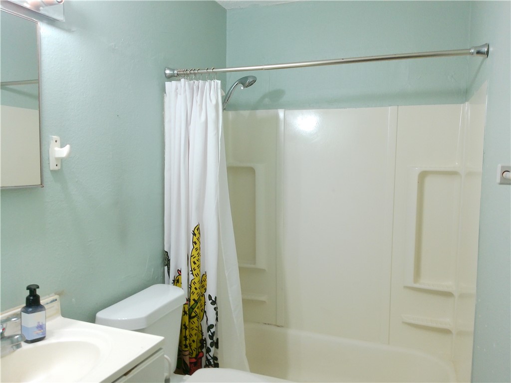 4006 McArdle Road Corpus Christi, TX 78411 - Photo 12 of 17 a bathroom with a sink and a shower