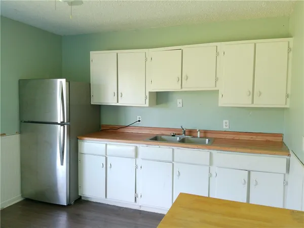 a kitchen with a refrigerator and window
