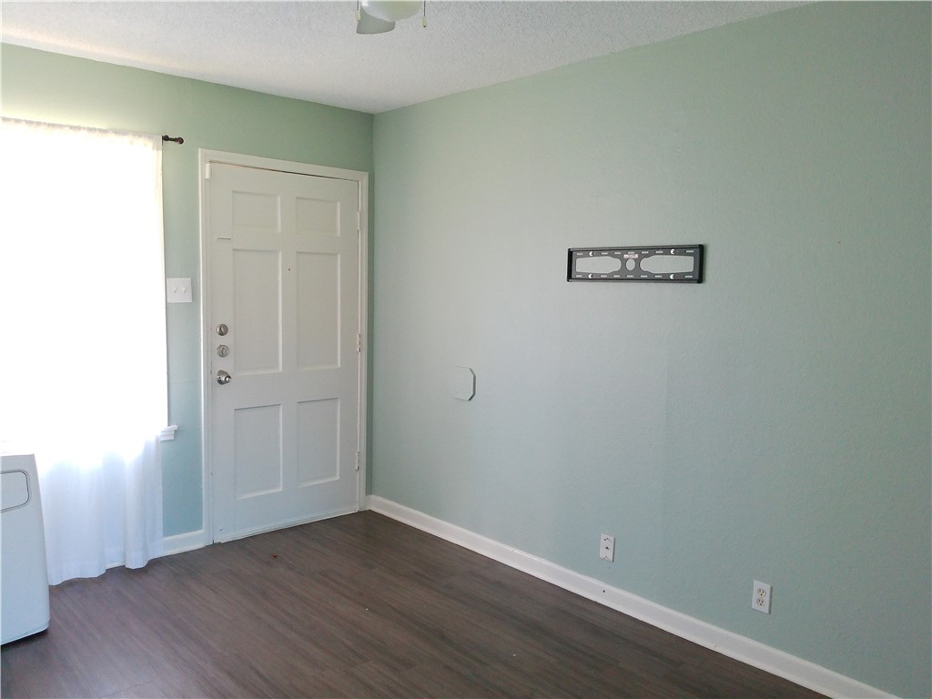 4006 McArdle Road Corpus Christi, TX 78411 - Photo 5 of 17 an empty room with wooden floor