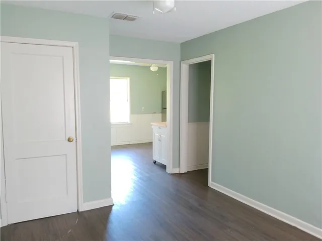 a view of a hallway with a wooden floor