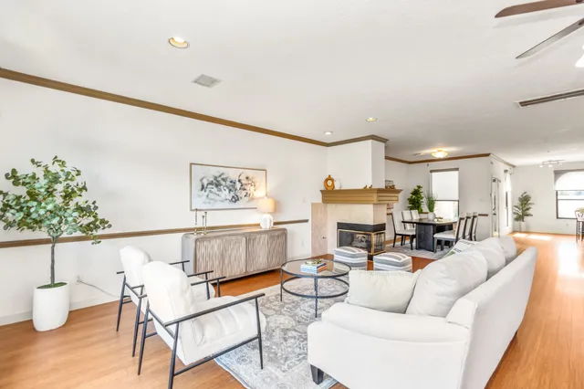 a living room with furniture and a painting on the wall