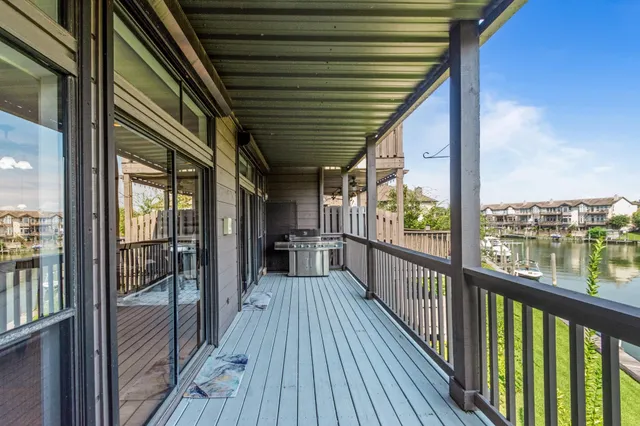 a view of a balcony with wooden floor