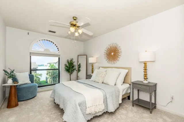 a spacious bedroom with a bed and a window