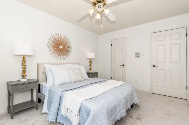 a bedroom with a bed and a chandelier