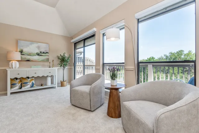 a living room with furniture and a floor to ceiling window