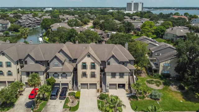 an aerial view of residential house with outdoor space and trees all around