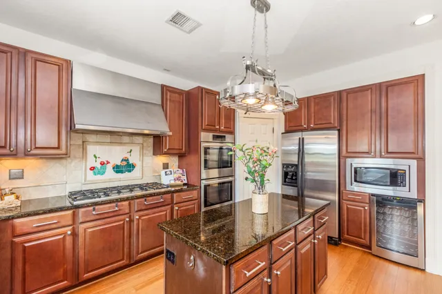 a large kitchen with lots of counter space and stainless steel appliances