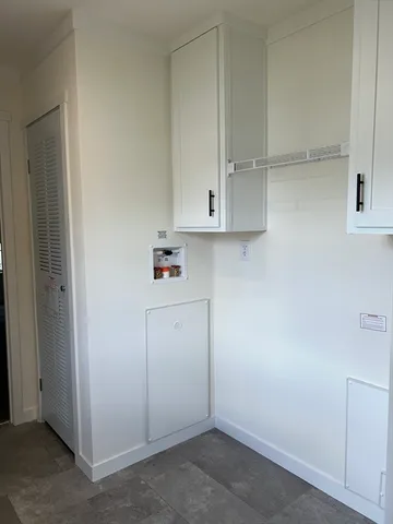 a view of cabinets and white cabinets
