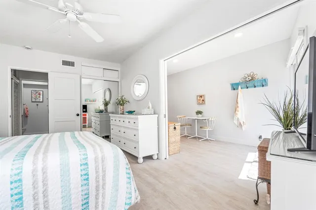 a bed room with a bed mirror and a desk