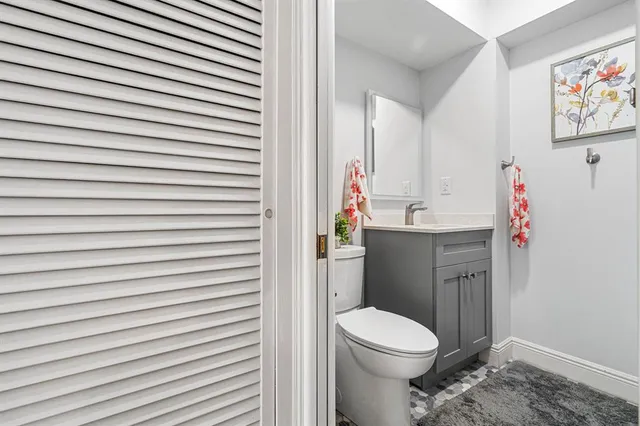 a white toilet sitting next to a bathroom sink
