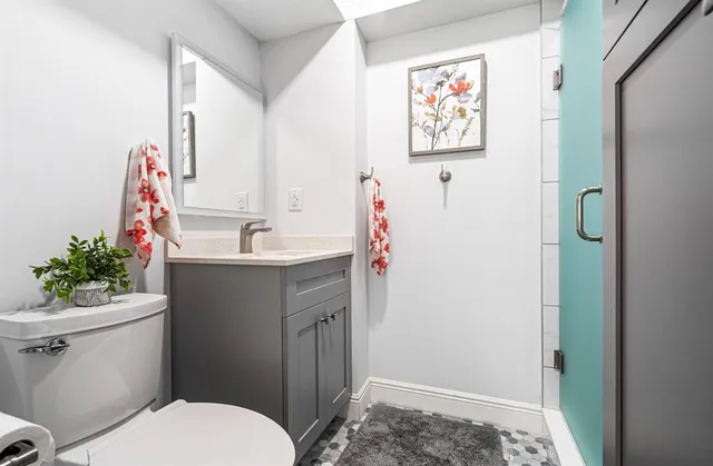 a bathroom with a sink mirror vanity and toilet