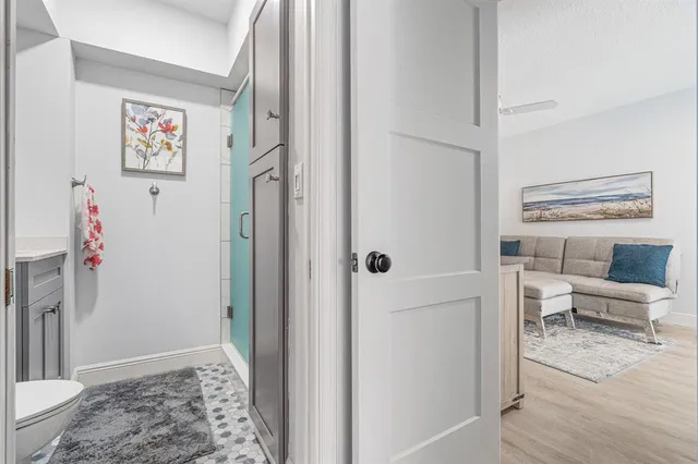 a view of a hallway with furniture and a livingroom
