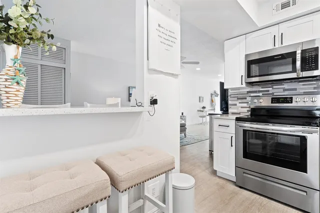 a kitchen with a sink stove and microwave