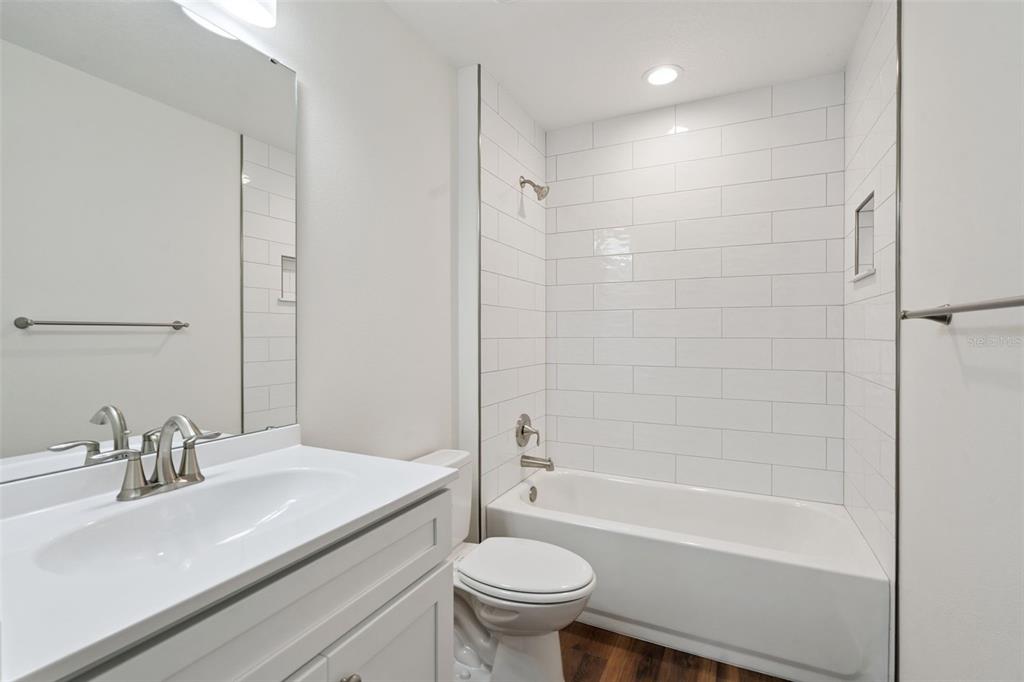 1075 North Rockingham Avenue Tavares, FL 32778 - Photo 12 of 16 a bathroom with a sink toilet and shower