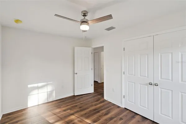 a view of an empty room with wooden floor