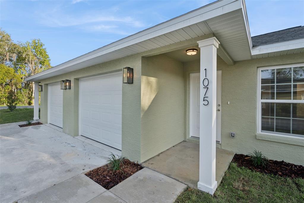 1075 North Rockingham Avenue Tavares, FL 32778 - Photo 2 of 16 a front view of a house with a yard