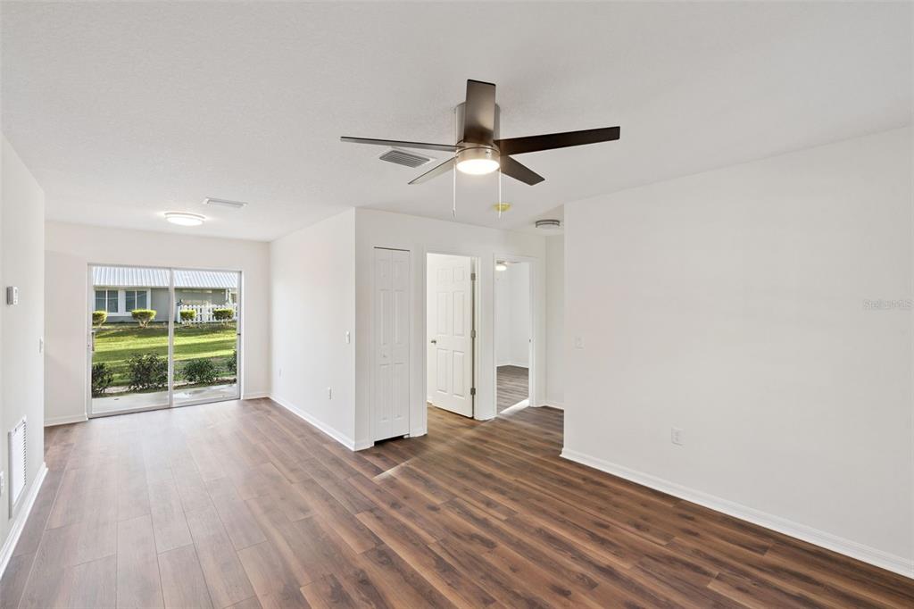 1075 North Rockingham Avenue Tavares, FL 32778 - Photo 3 of 16 a view of empty room with wooden floor and fan