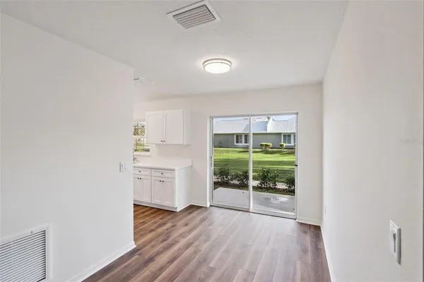 an empty room with wooden floor and a window