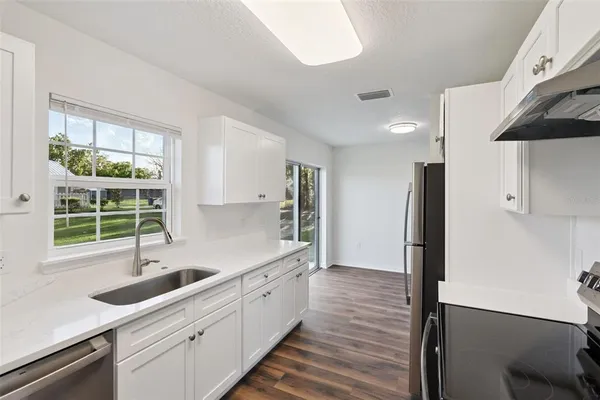 a kitchen with sink cabinets and window
