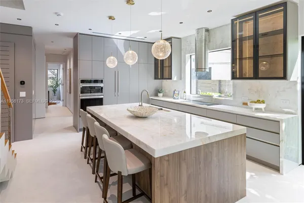 a kitchen with a stove a refrigerator and a dining table