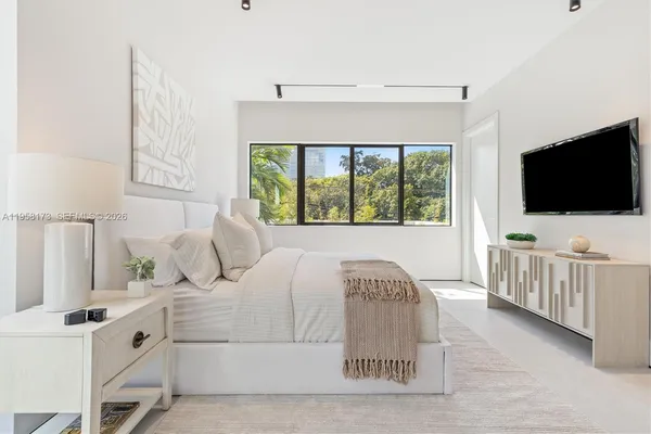 a large white bed in a white room