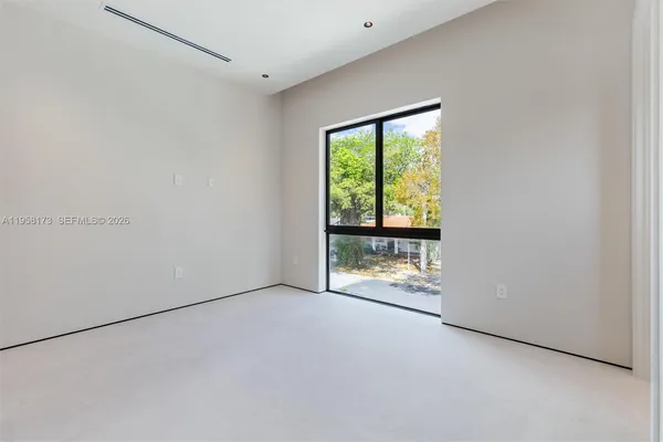 a reading room with furniture and a flat screen tv