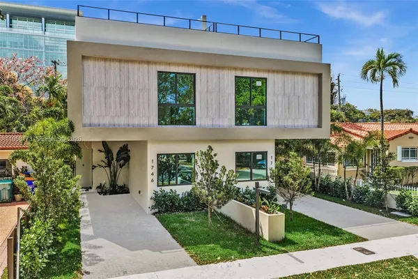 a front view of a house with garden