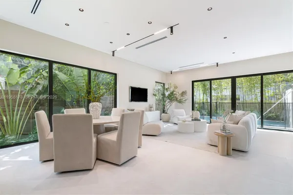 a living room with furniture and large windows