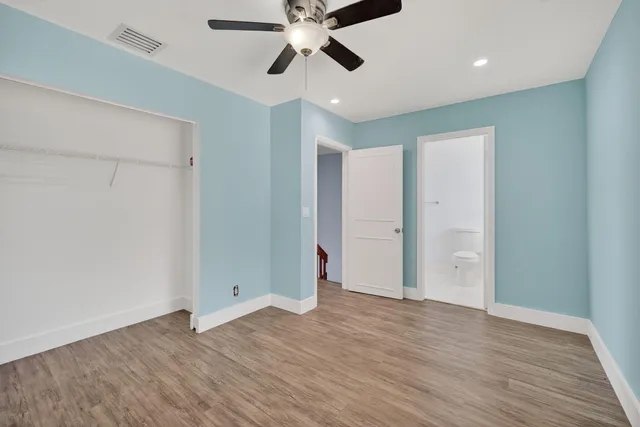 a view of an empty room and window wooden floor