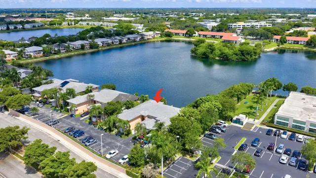 an aerial view of residential houses with outdoor space and lake view