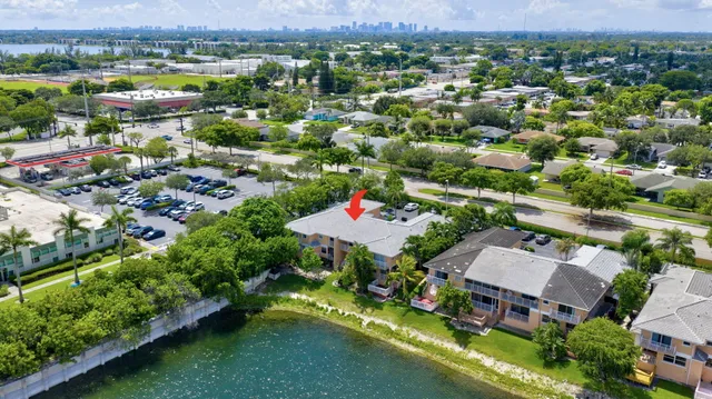 an aerial view of residential houses with outdoor space and lake view