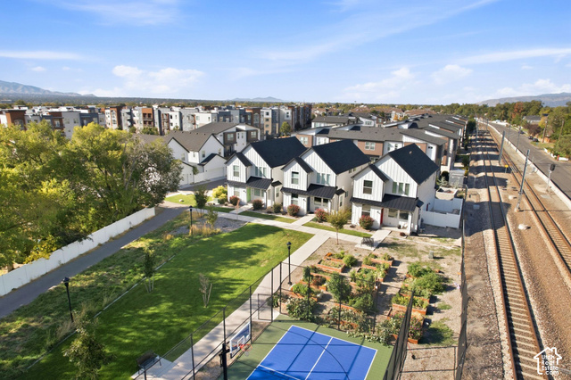 153 East Rochefort Court Sandy, UT 84070 - Photo 41 of 43 Modern townhome community featuring a recreational court, expansive green space, garden plots, and contemporary architectural design