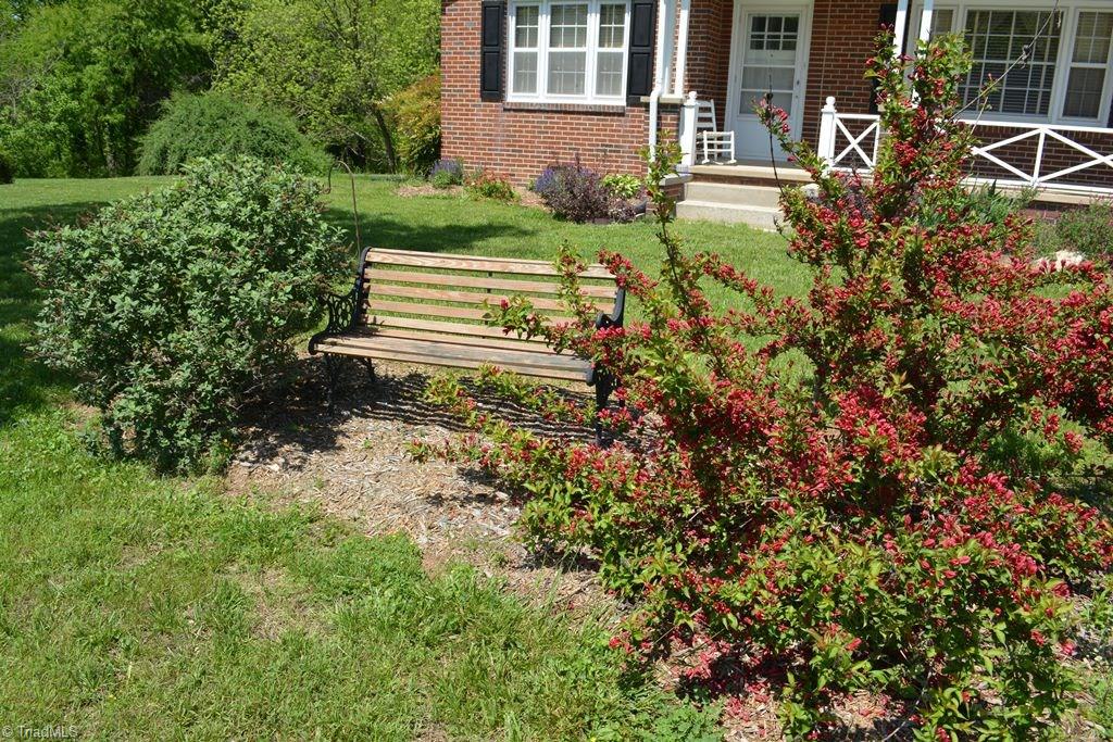 112 Cedarbrook Road Jonesville, NC 28642 - Photo 3 of 21 Cute bench in front to enjoy the summer days!