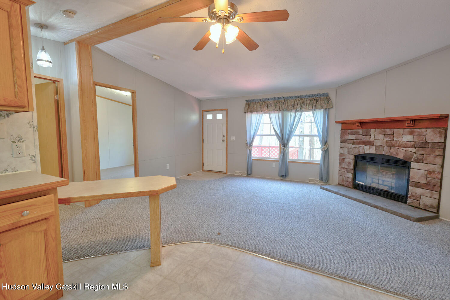 201 Edison Timmerman Road Cairo, NY 12413 - Photo 13 of 49 a view of an empty room with a fireplace and a window