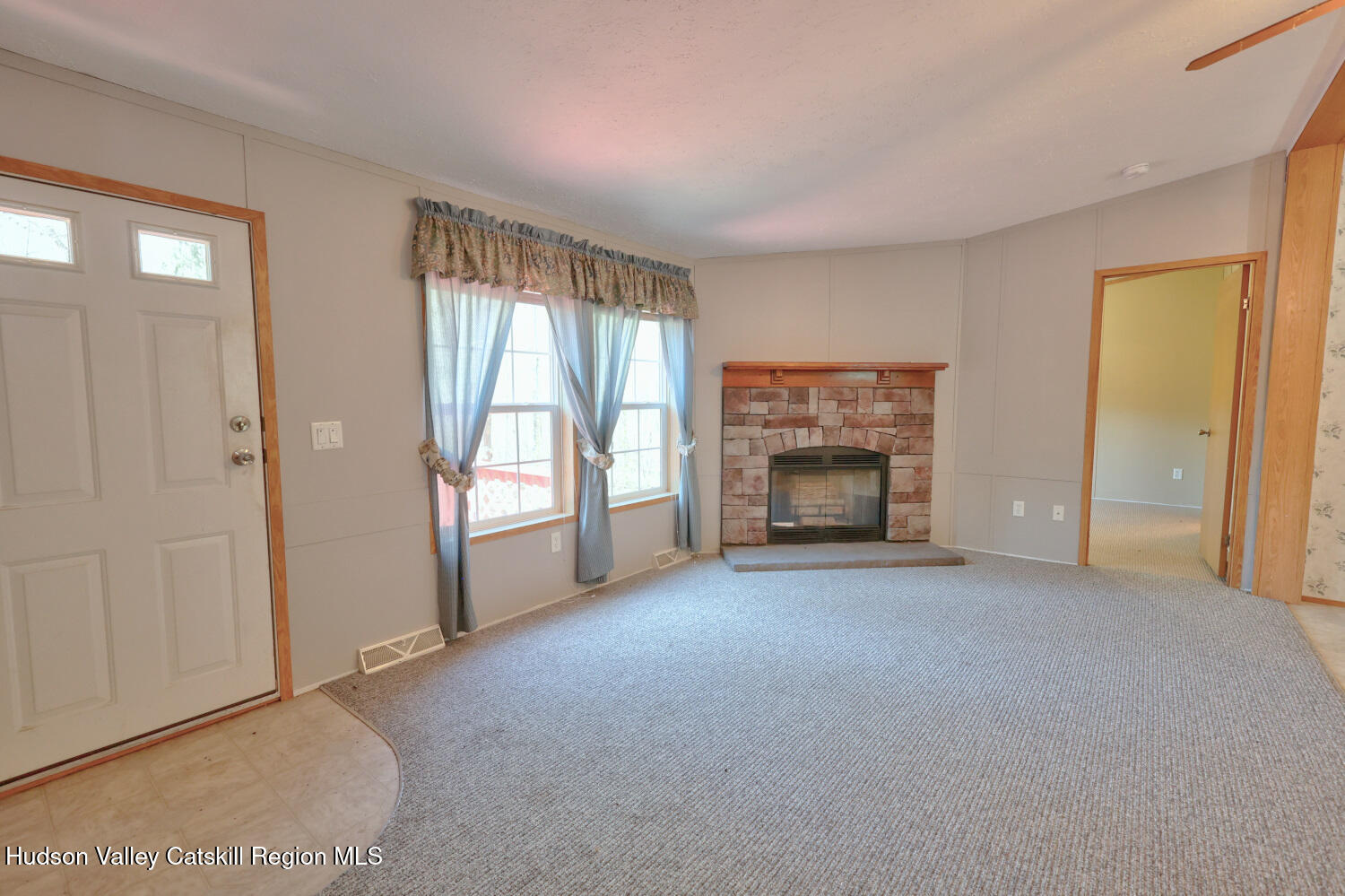 201 Edison Timmerman Road Cairo, NY 12413 - Photo 16 of 49 a view of an empty room with a fireplace and a window