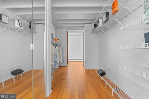 a bedroom with bed and wooden floor