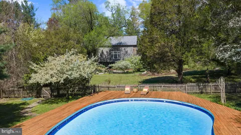 a view of a swimming pool with an outdoor space and seating area