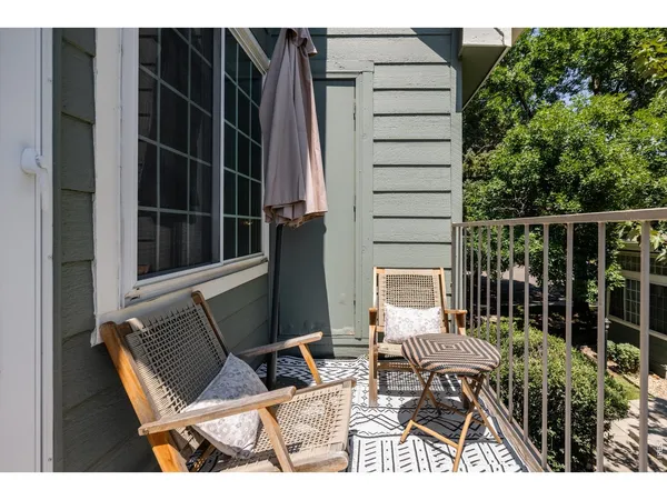 a balcony with table and chairs