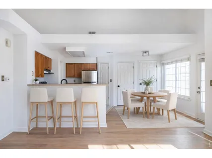 a view with dining table chairs and entryway