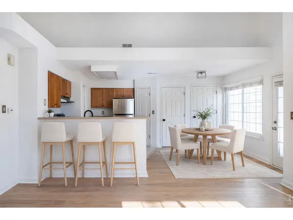a view with dining table chairs and entryway