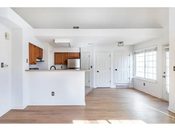 a view of a kitchen with wooden cabinet
