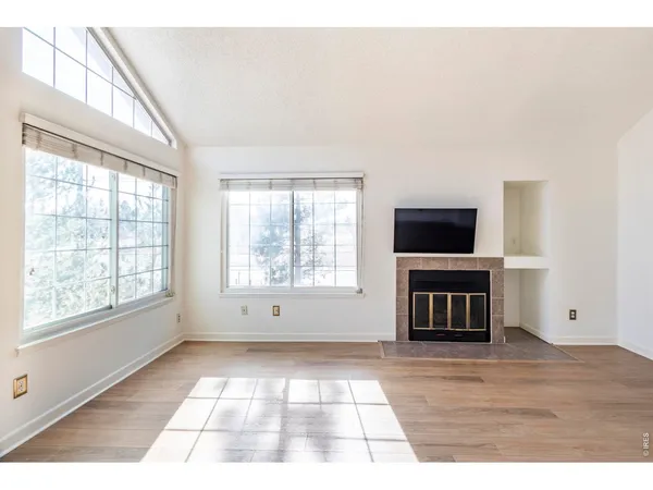 a view of empty room with window and fireplace
