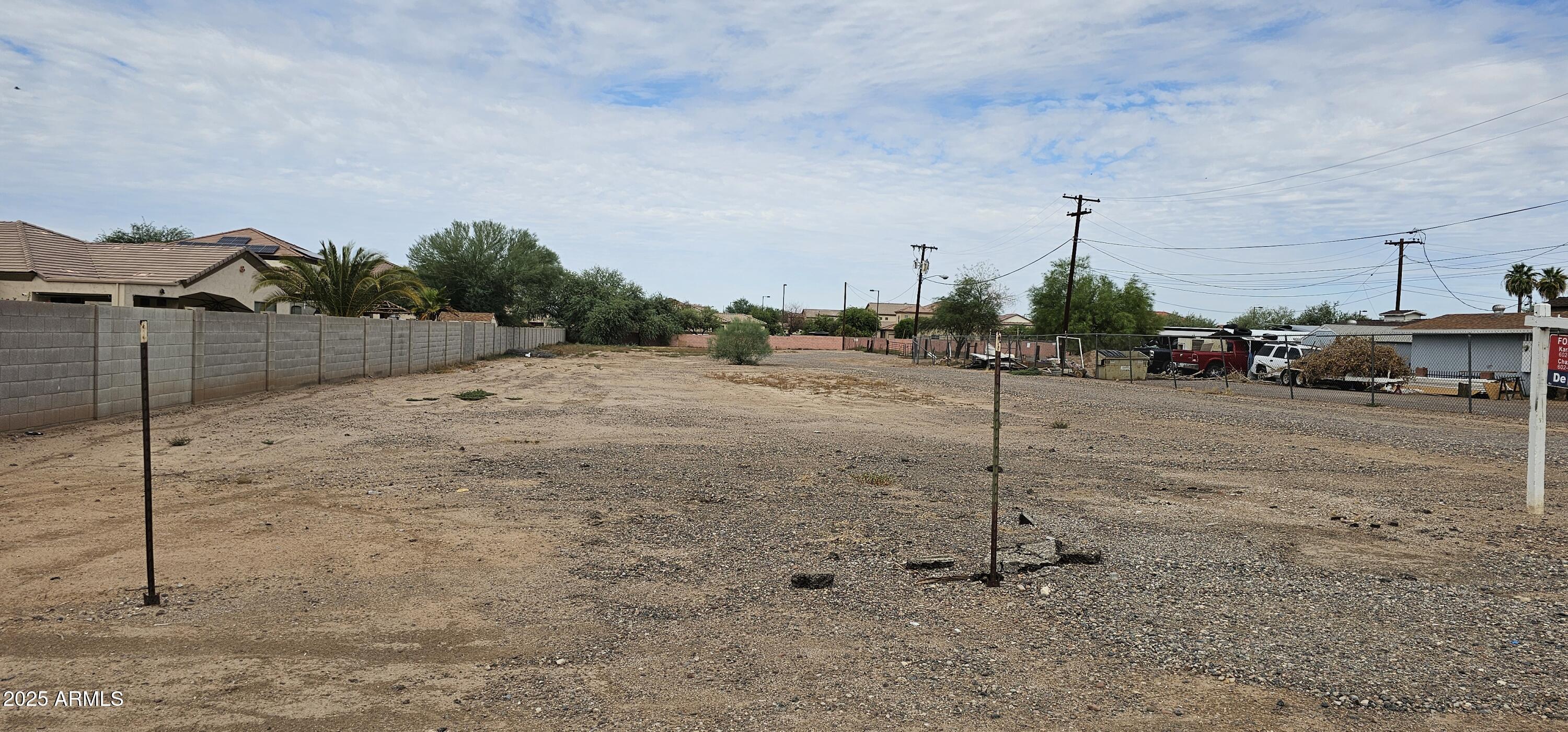 129 South 1st Street Buckeye, AZ 85326 - Photo 14 of 16 a view of a dry yard with wooden fence